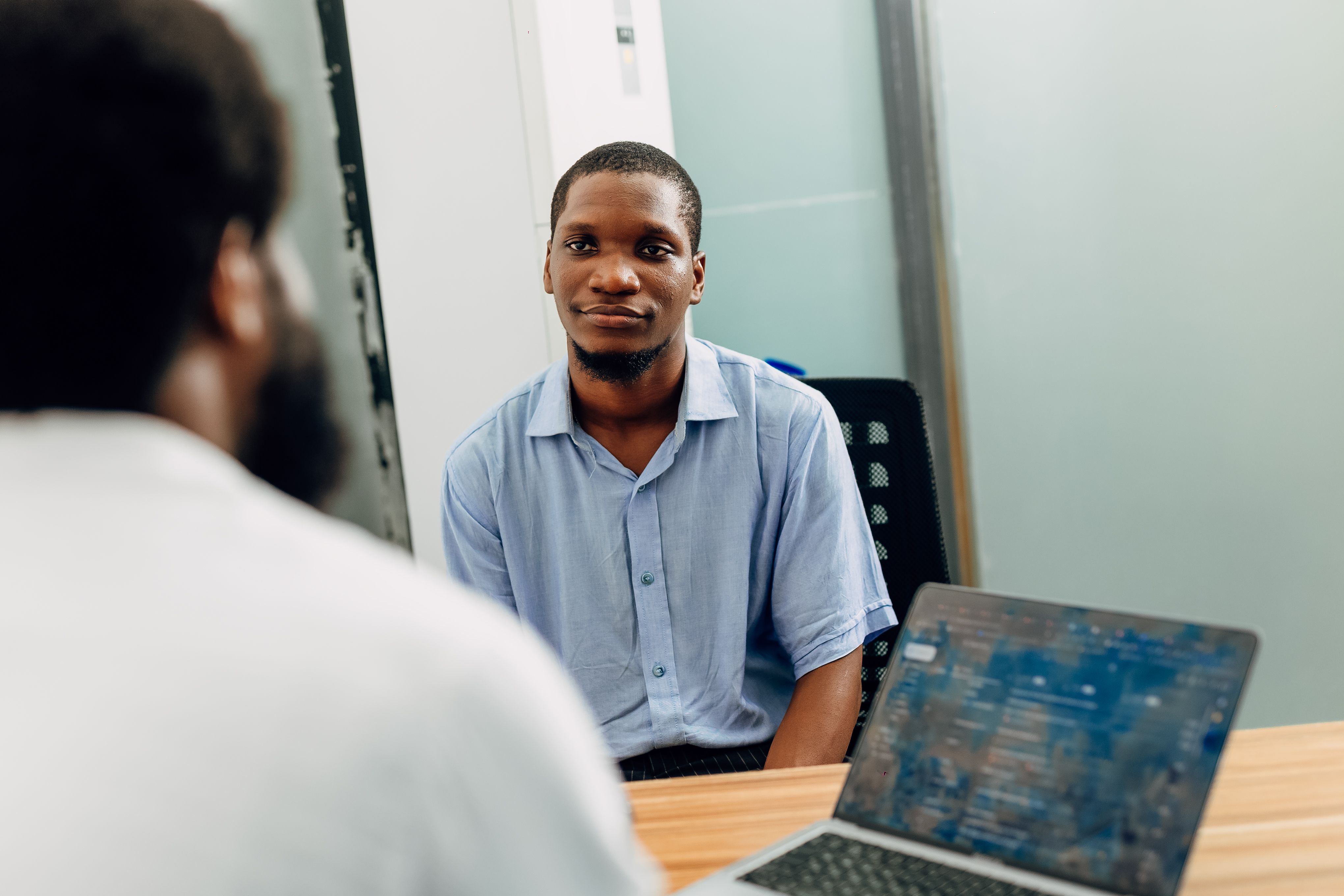 Two professionals in a job interview in a modern office