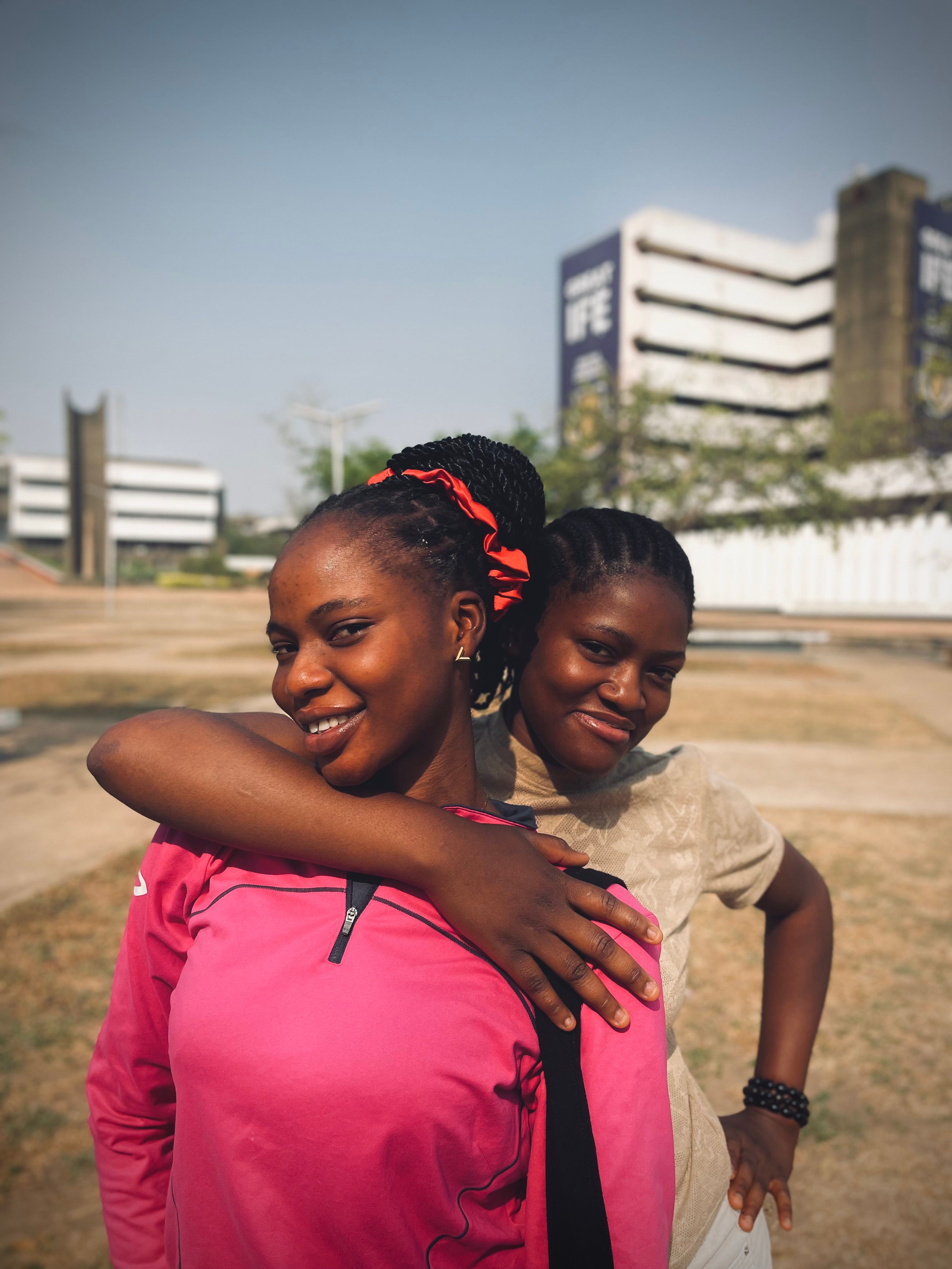 Students smiling outdoors on a university campus