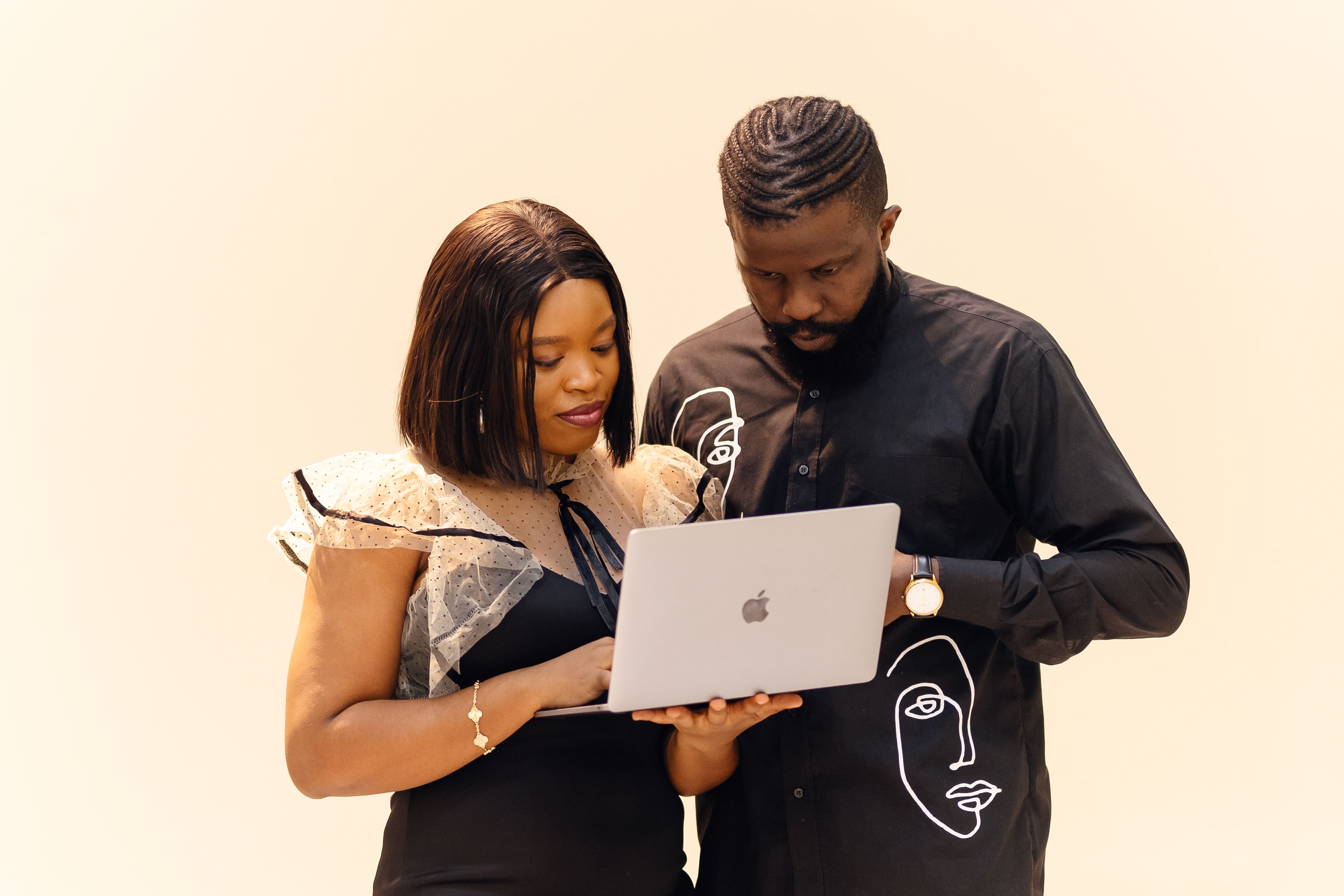 Two colleagues collaborating over a laptop in an office