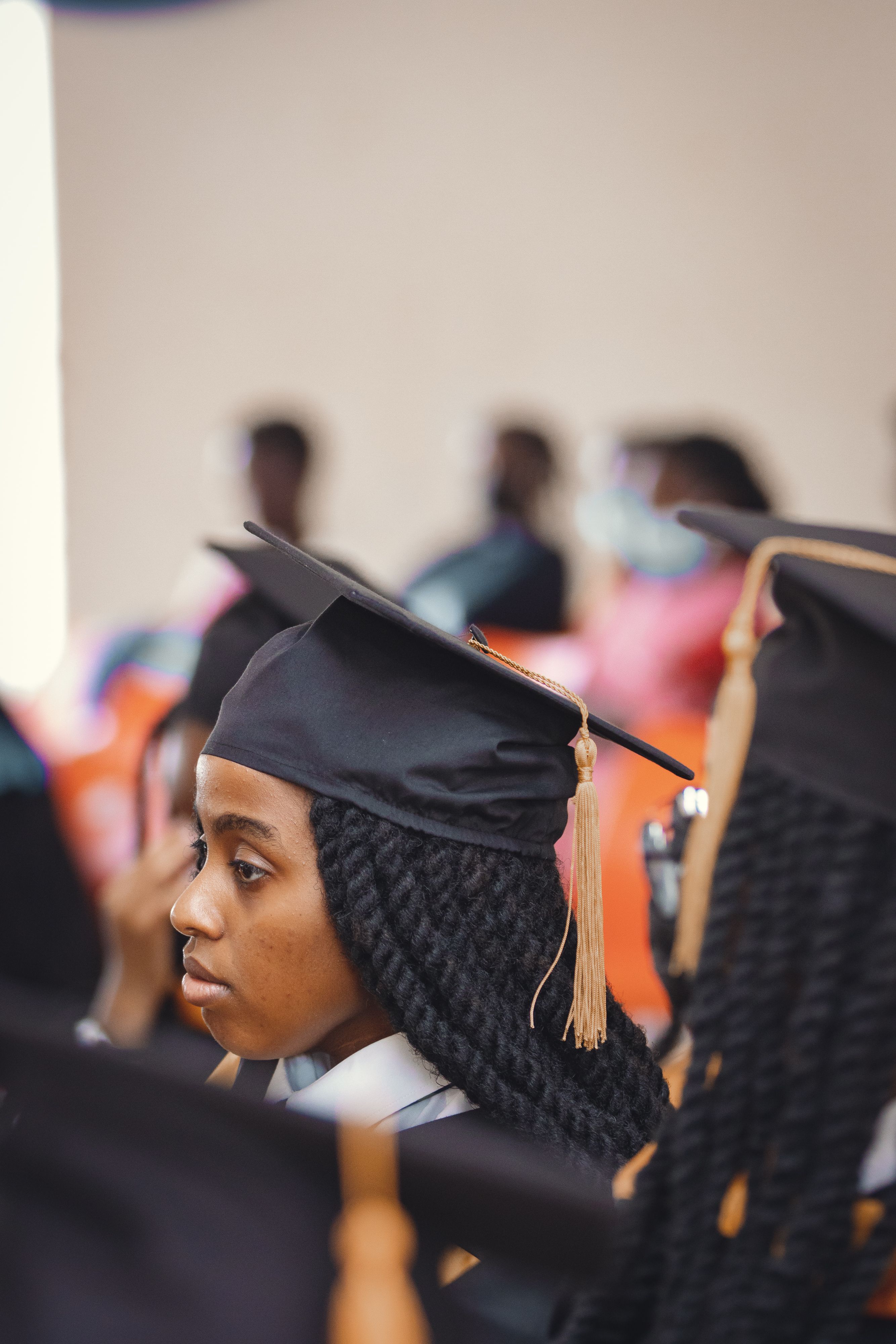 A graduate wearing a cap and gown at a university graduation ceremony